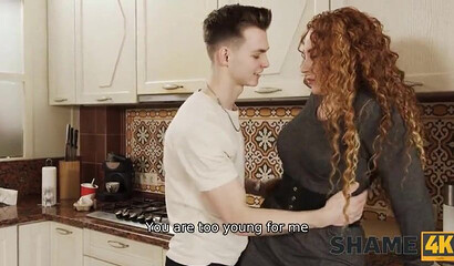 Curly-haired housewife Tanya Foxx screws a teen neighbor in the kitchen