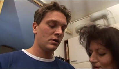 Busty mature woman in black lingerie schools a young boy