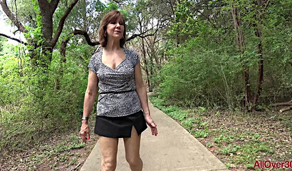 Shameless granny Lynn walks in a short skirt without panties