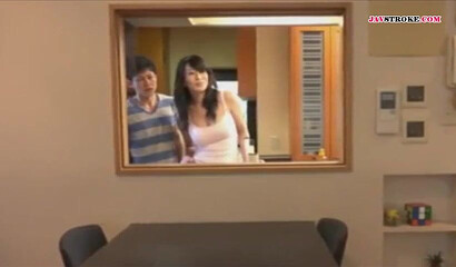 Son plays with mom in the kitchen and dad almost caught them